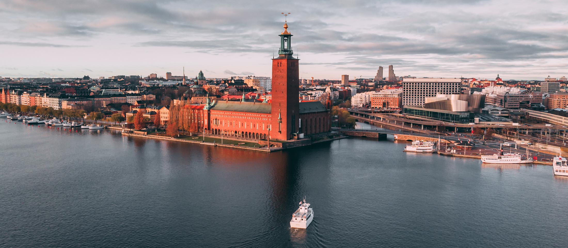 Stockholm-City-Hall-at-Sunset-FG-banner-1 Drone shot of Stockholms City Hall at sunset. Photo by Francisco Gutiérrez